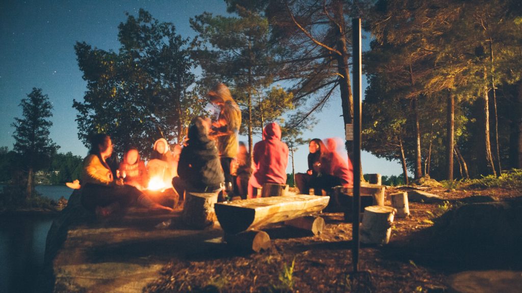 people gathered around a camp fire